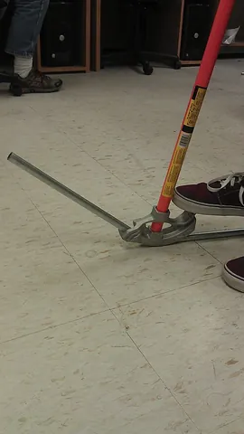conduit bender: a tool used in conjunction with a very long lever to bend angles in a conduit that electric wires...