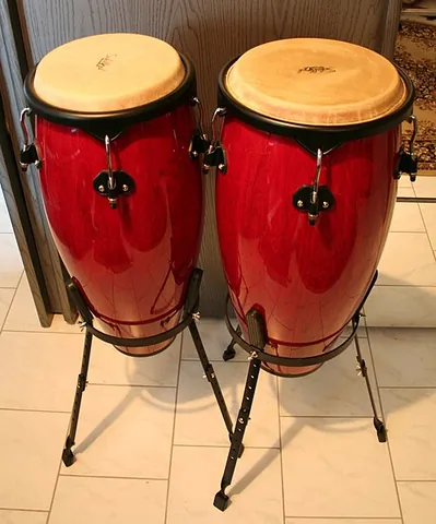 conga: a tall, narrow, single-headed Cuban hand drum of African origin