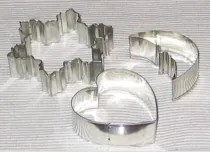 cookie cutter: a device used to cut flattened dough into shapes before baking
