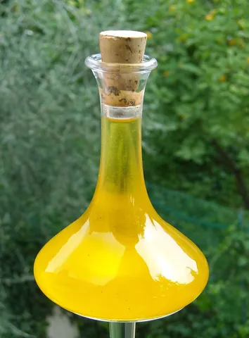cooking oil: a purified fat taken from plant material that is commonly used in cooking, e.g. olive oil, canola...
