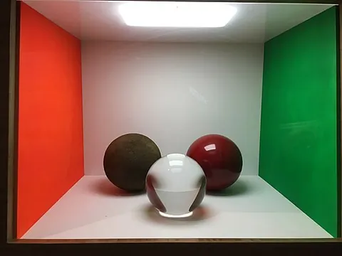 cornell box: a physical box with variously coloured walls and an inner light source, photographed and used to...