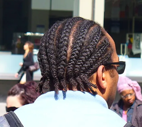 cornrow: one of a set of rows of tightly braided hair close to the scalp, forming a hairstyle, of African...