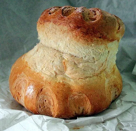 cottage loaf: a traditional English loaf of bread shaped like two round loaves, one on top of the other