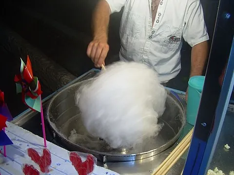 cotton candy: a confectionery made by spinning melted sugar into thin threads collected into a mass