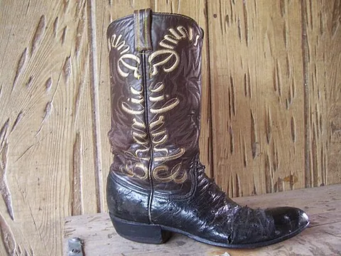 cowboy boot: a kind of riding boot, historically worn by cowboys, with a high heel traditionally made of stacked...