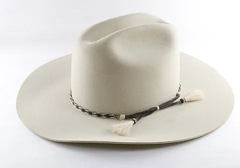 cowboy hat: a broad-brimmed hat worn by cowboys, ranchers, and farmers, common in the western United States and...