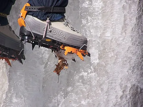 crampon: an attachment to a shoe or boot that provides traction by means of spikes for climbing or walking...