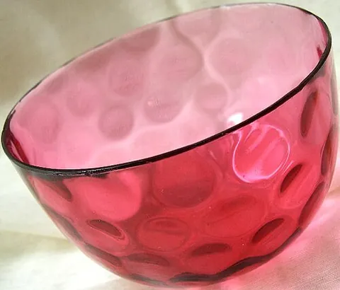 cranberry glass: a type of reddish-pink transparent glass made by adding gold salts or colloidal gold to molten...