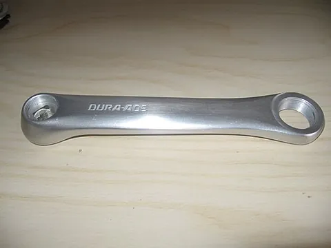 crank arm: one of the two lever components that attach the bottom bracket spindle to a pedal