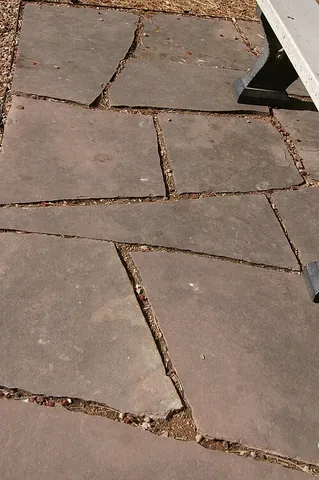 crazy paving: paving with pieces of irregular size and shape that fit together and (approximately) cover the...