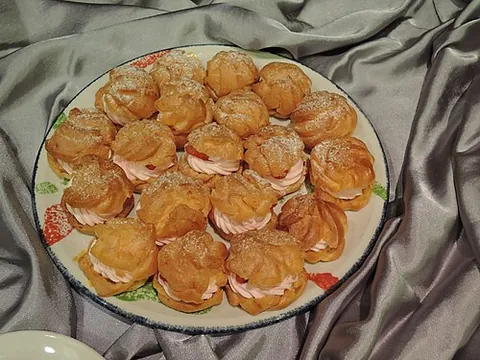 cream puff: a light, hollow pastry typically filled with cream or custard