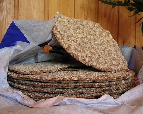 crispbread: a type of flat, dry bread or cracker, usually baked of rye flour, popular in the Nordic countries