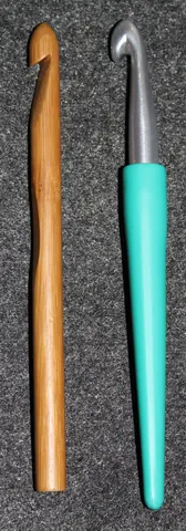 crochet hook: a needle with a small hook at one end, used to make crochetwork (a type of hand-knitted textile)