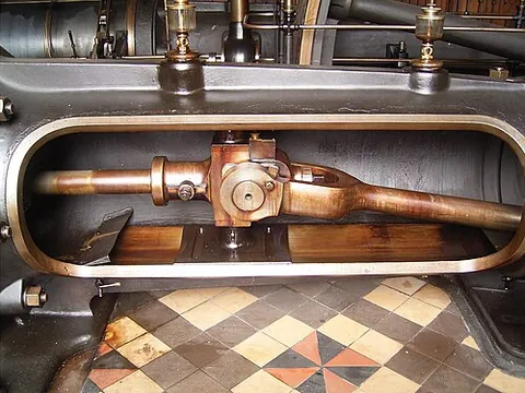 crosshead: a metal beam that connects a piston to a connecting rod in an engine