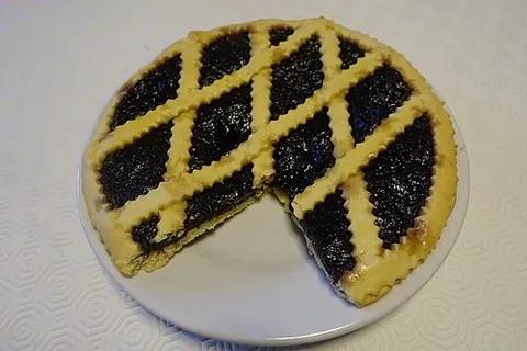 crostata: a kind baked tart of Italian origin, made with shortcrust pastry spread over a baking sheet, then...