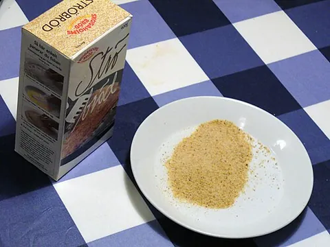 crumb: a small piece which breaks off from baked food (such as cake, biscuit or bread)