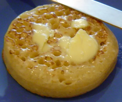 crumpet: a type of savoury cake, typically flat and round, made from batter and yeast, containing many small...