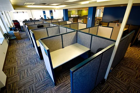 cubicle: a small separate part or one of the compartments of a room, especially in a work environment