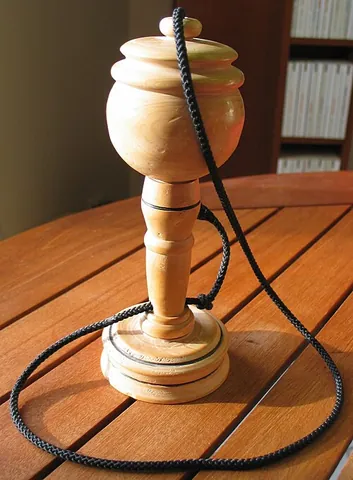cup-and-ball: a traditional children's toy consisting of a hand-held wooden cup with a ball attached by a string....