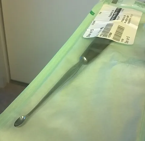curette: a hand-held surgical instrument, often with a scoop or hook at its tip, used for cleaning or...