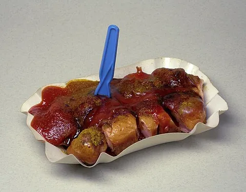 currywurst: a German national dish consisting of hot pork sausage cut into slices and seasoned with curry...