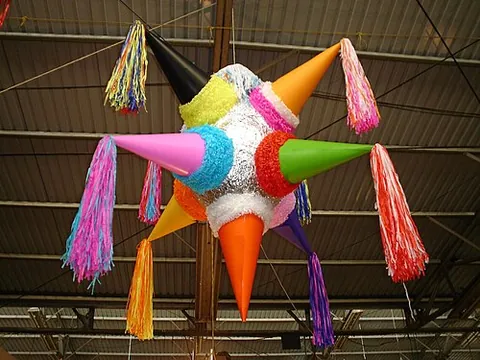 piñata: a doll or other decorated container that is filled with candy and hit with a hammer or a stick by...