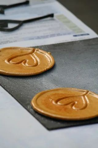 dalgona: a Korean sweet made of sugar and baking soda, usually pressed flat and stamped with a shape