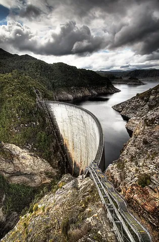 dam: a structure placed across a flowing body of water to stop the flow or part of the flow, generally...
