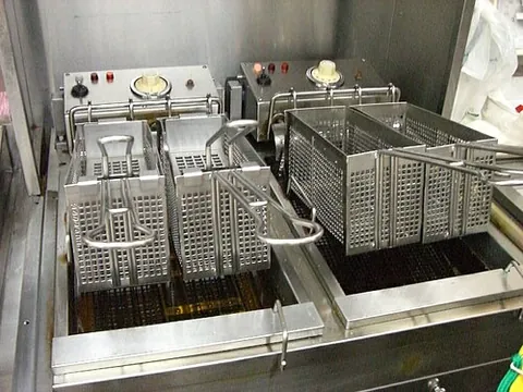 deep fryer: a heated vessel for frying food by immersing in hot oil, as opposed to shallow frying in a frying...