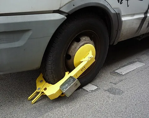 denver boot: a device locked into place over the wheel of a road vehicle, immobilizing it