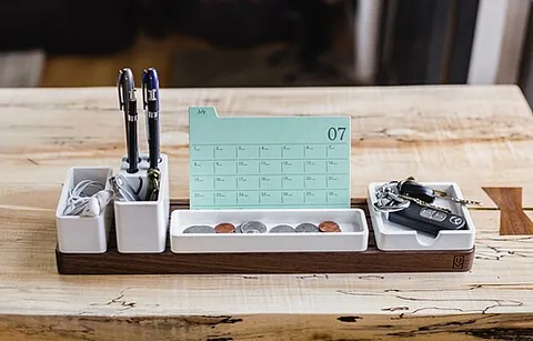 desk organizer: a box or open tray, typically kept on the surface of a desk, divided into compartments for such...