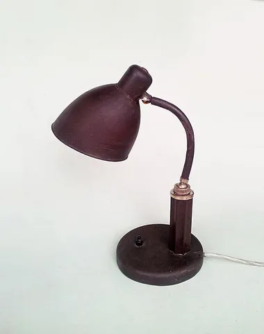 desklamp: a lamp which sits on and is used to illuminate a desk