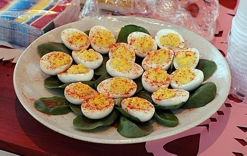 deviled egg: a hard-boiled chicken egg that has been shelled, cut in half, and filled with a paste made from the...