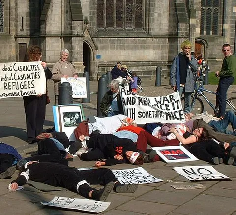 die-in: a form of protest where a group of people in a public area lie on the ground to simulate being dead