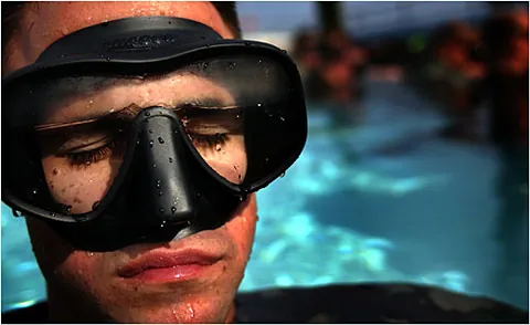 diving mask: a mask worn by divers over the eyes or face to allow them to see clearly underwater, having a...