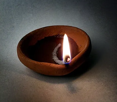diya: a small bowl-shaped oil lamp, usually made from clay, with a cotton wick dipped in ghee or...
