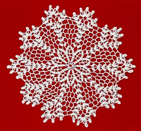 doily: a small ornamental piece of lace or linen or paper used to protect a surface from scratches by hard...