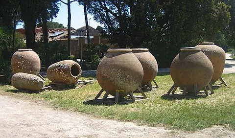 dolium: a large earthenware vessel used for the storage and transportation of goods (especially wine an...