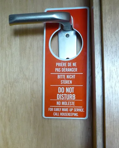 door hanger: a sign or advertisement that is cut so that it can be hung from the handle or knob of a door