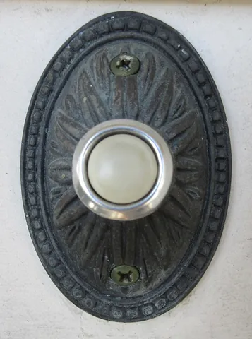 doorbell: a bell, buzzer, or chime device mounted on or adjacent to a door's exterior, meant to be rung by a...