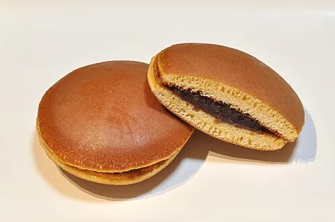 dorayaki: a Japanese confection consisting of two sponge cake patties baked to resemble gongs, sandwiching a...