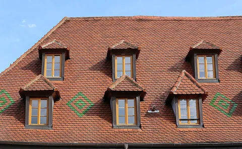 dormer: a room-like, roofed projection from a sloping roof