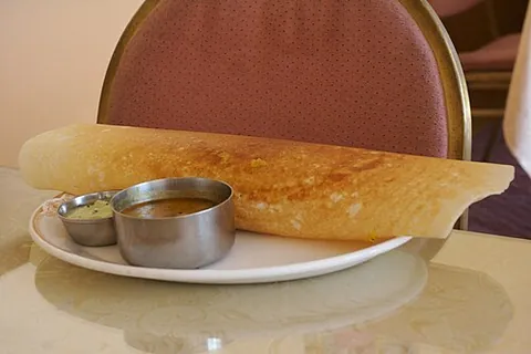 dosa: a type of thin south Indian pancake made from fermented lentils and rice blended with water,...