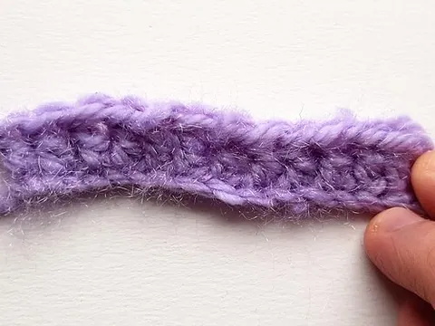 double crochet: a crochet stitch achieved by: yarn over, push through next loop, yarn over and pull back through,...