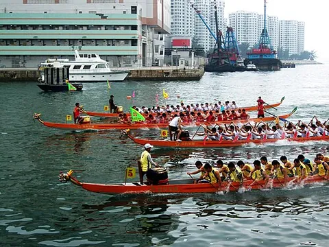 dragon boat: a type of boat raced in Chinese festivals featuring a dragon motif and twenty paddling, one...