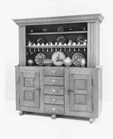 dresser: an item of kitchen furniture, like a cabinet with shelves, for storing crockery or utensils