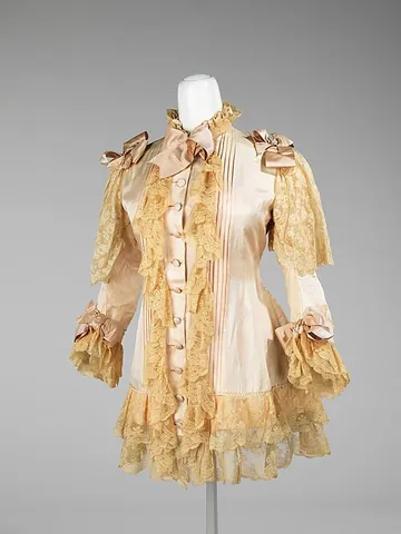 dressing jacket: a loose-fitting lightweight garment, usually hip- to thigh-length, generally worn at home while...
