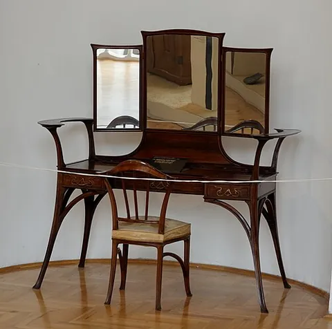 dressing table: a low table or chest of drawers with a mirror at which one sits while dressing, applying makeup or...