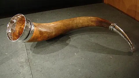 drinking horn: a drinking vessel fashioned from an animal's horn