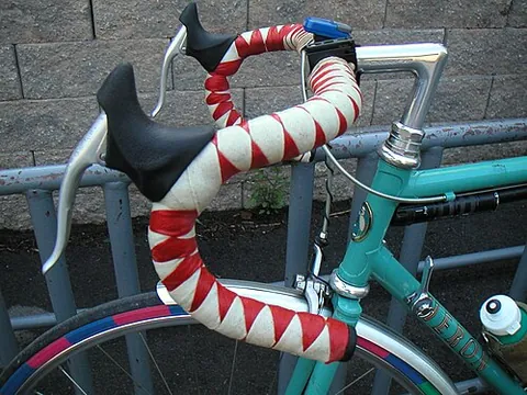 drop handlebar: a type of curved handlebar typically used on racing bicycles